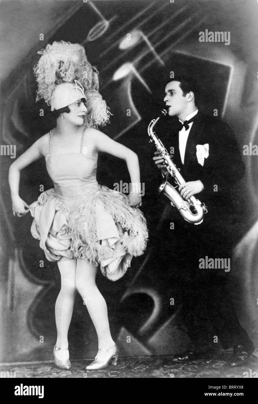 Woman dancing, man playing saxophone, Jazz, historic photograph, around