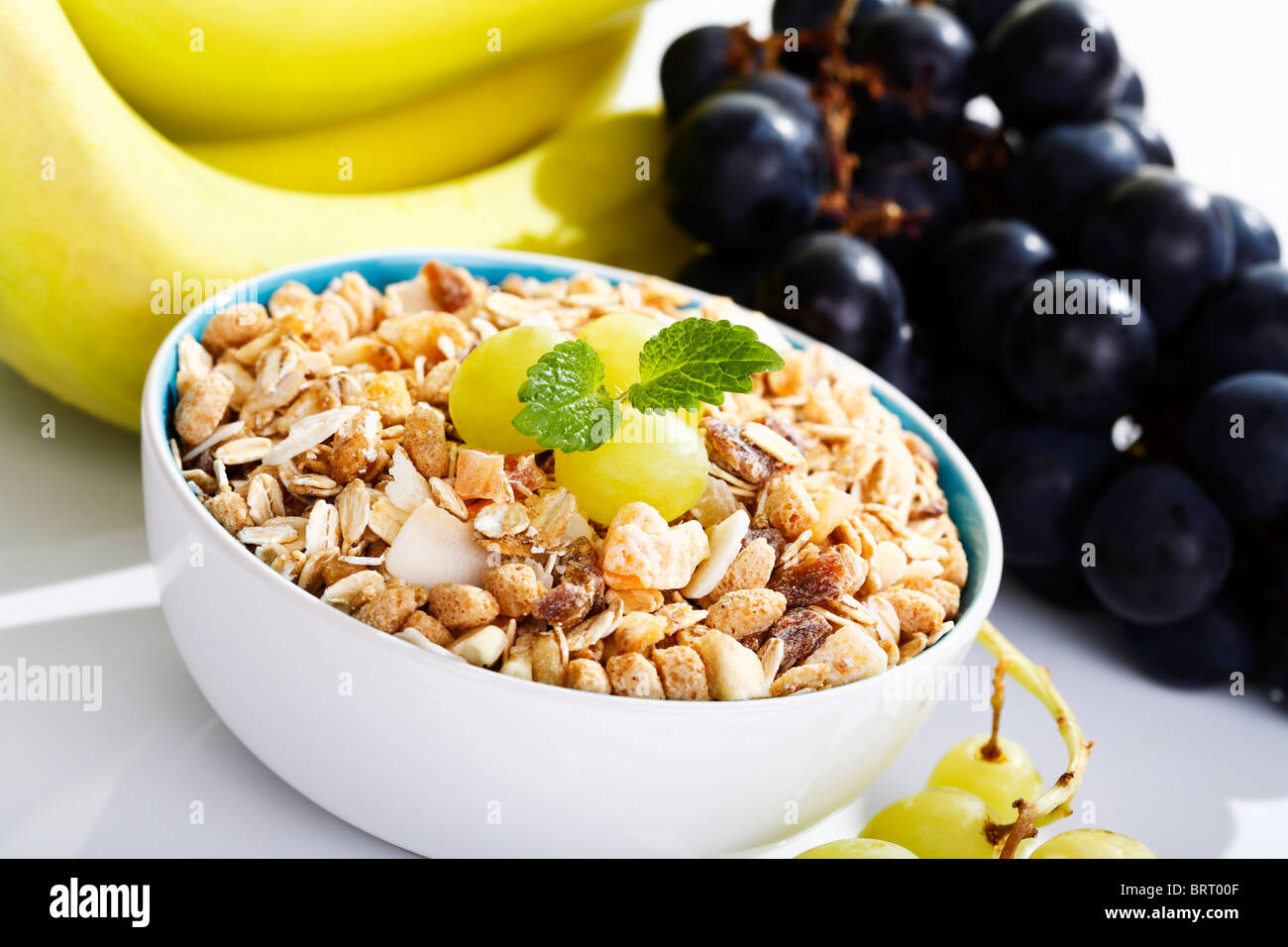 Exotic fruit muesli and grapes in a bowl Stock Photo