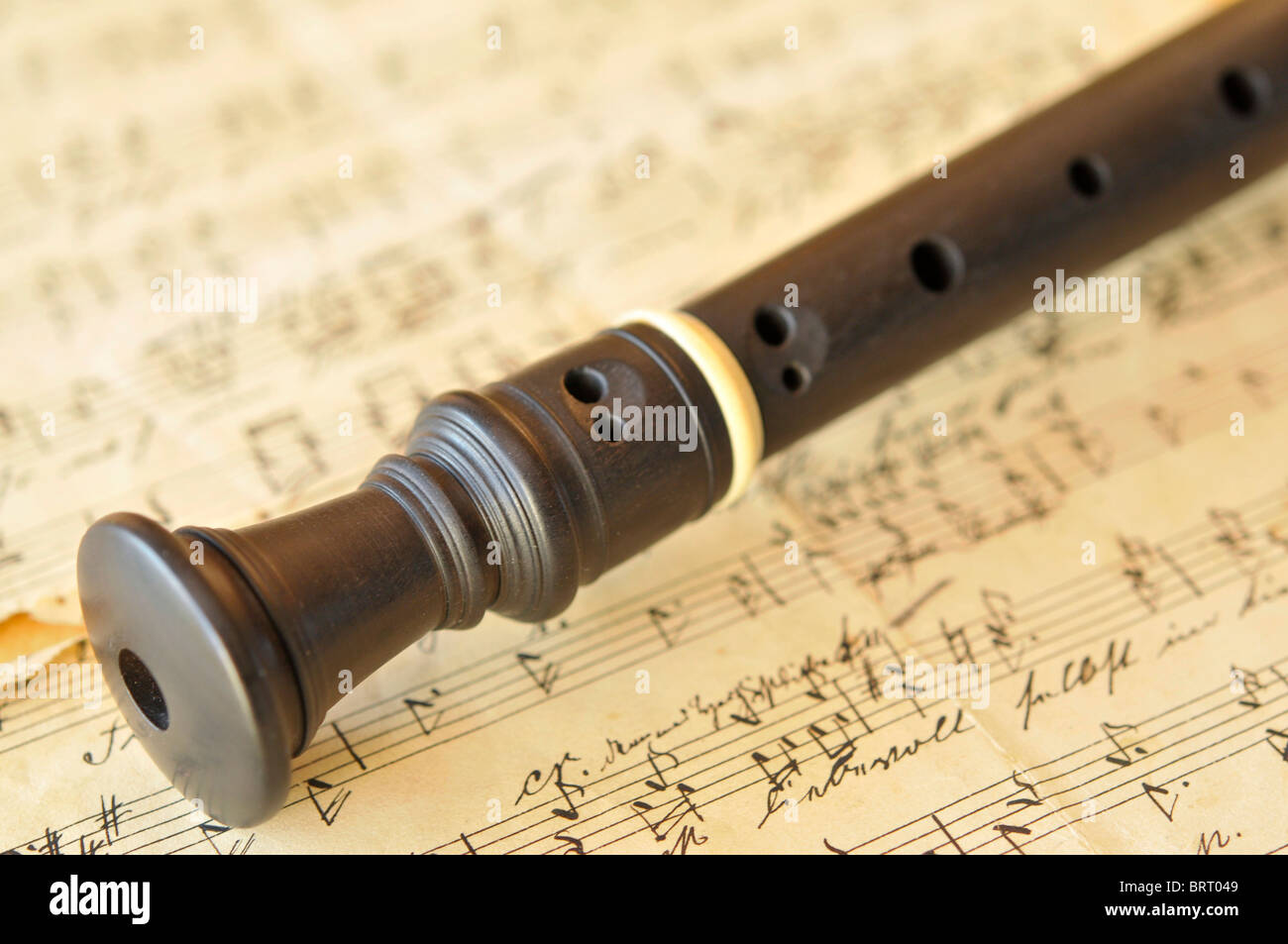 Ebony sopran flute on an old sheet of music Stock Photo Alamy