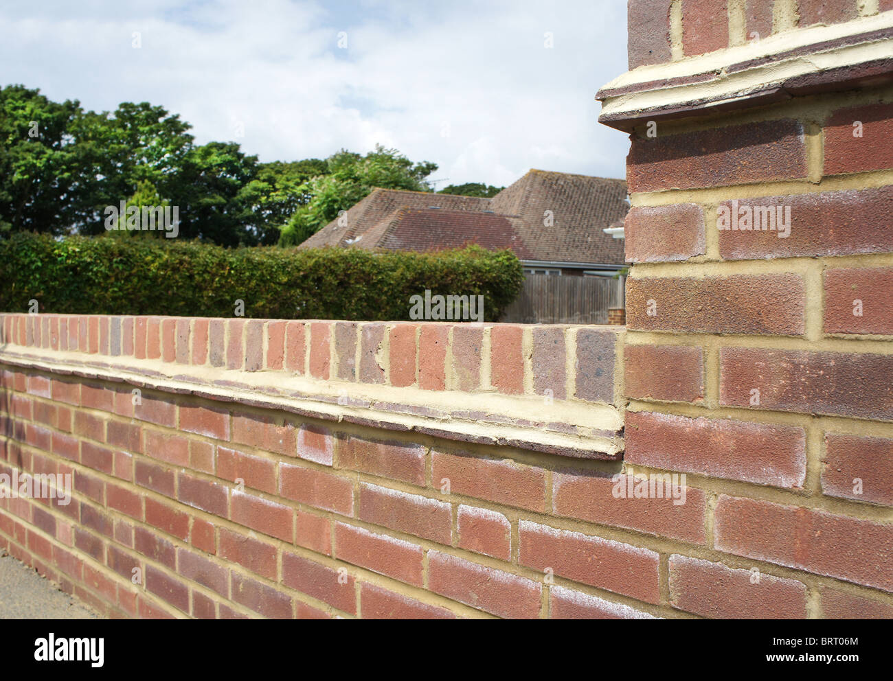 Newly constructed brick wall at the front of a house. Focus on foreground. Stock Photo