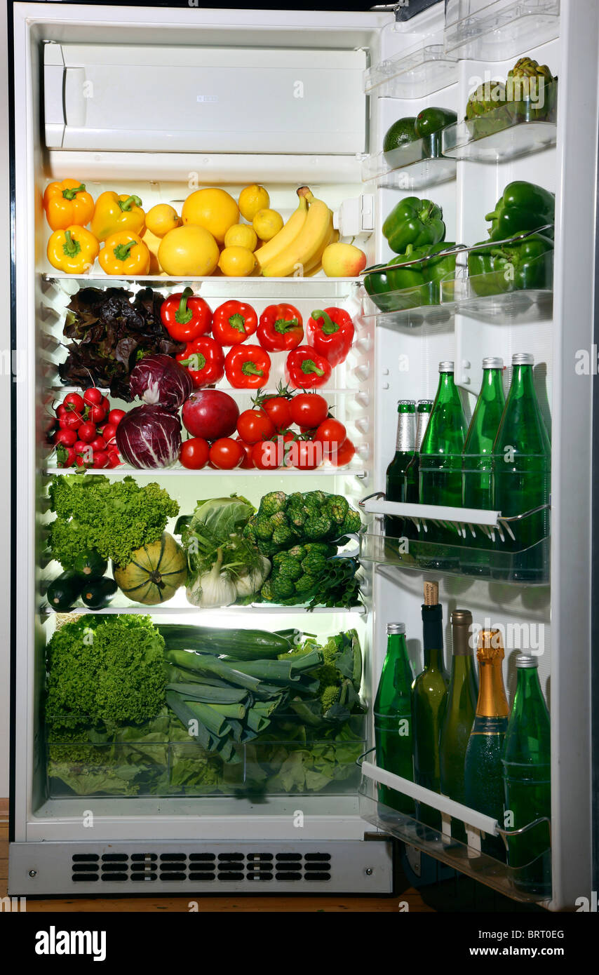 Refrigerator filled with many different vegetables, fruits, salads