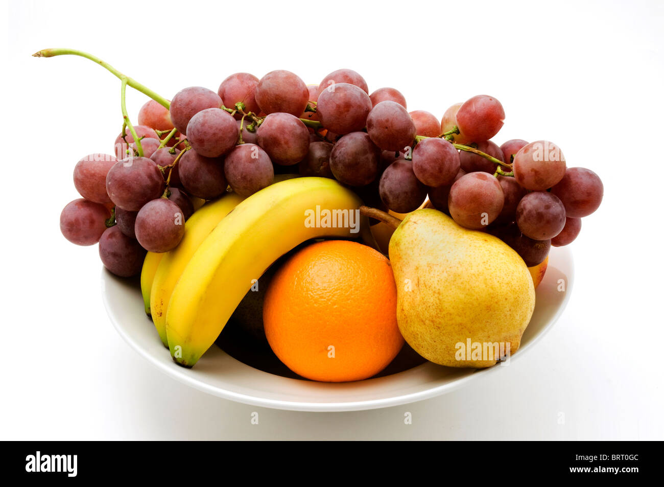 Bowl of fruit on a white background Stock Photo