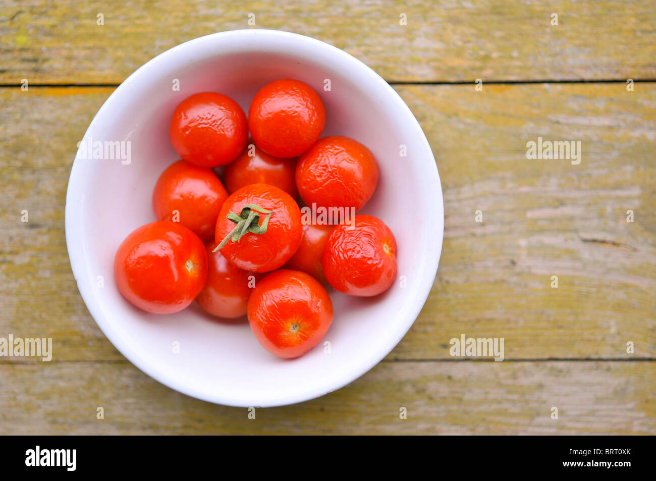 Overripe tomatoes in a bowl Stock Photo