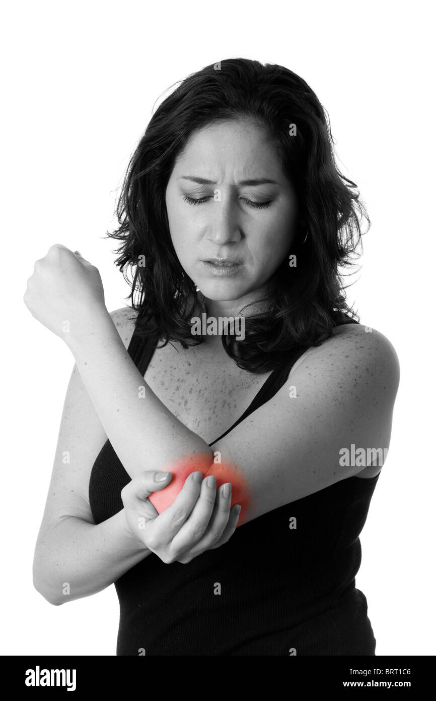 Beautiful woman holding her elbow with pain and arm ache,wearing a sporty black tank top, isolated. Stock Photo