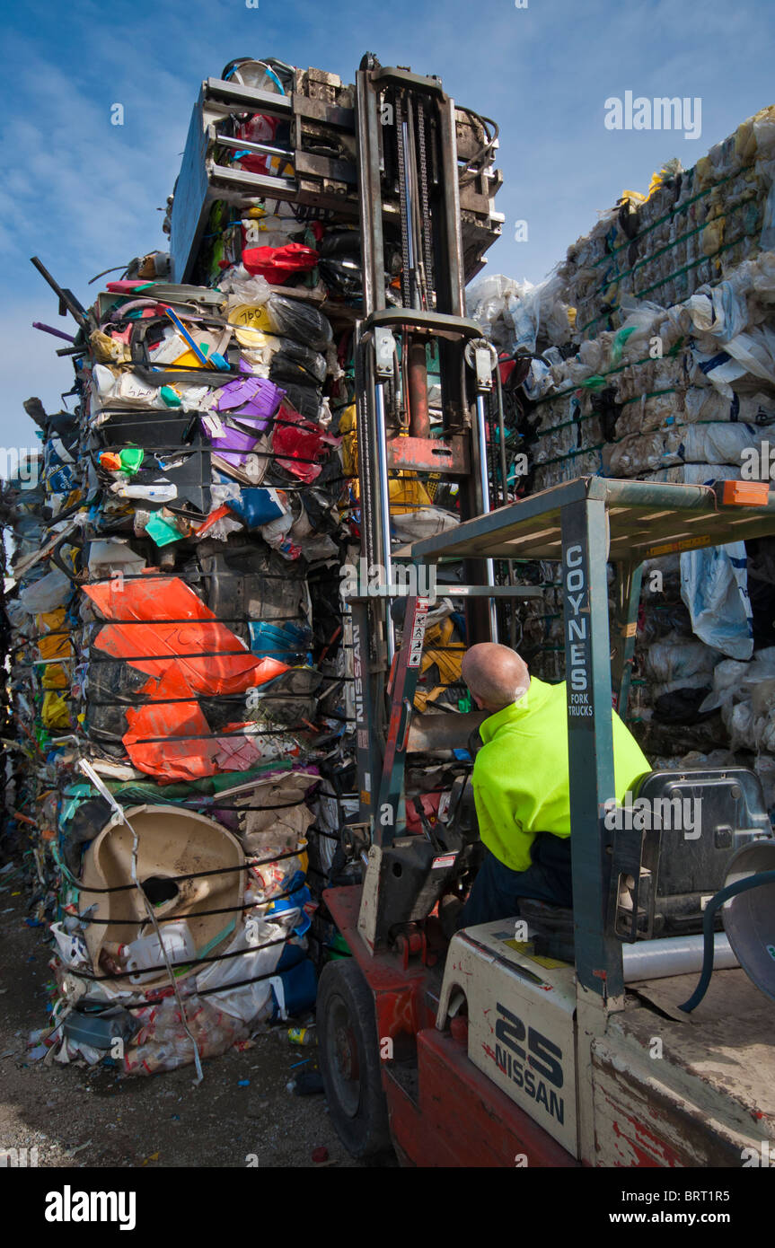 Stacking one tonne bales of plastic with a forklift at a plastics recycling plant in Geelong Australia Stock Photo