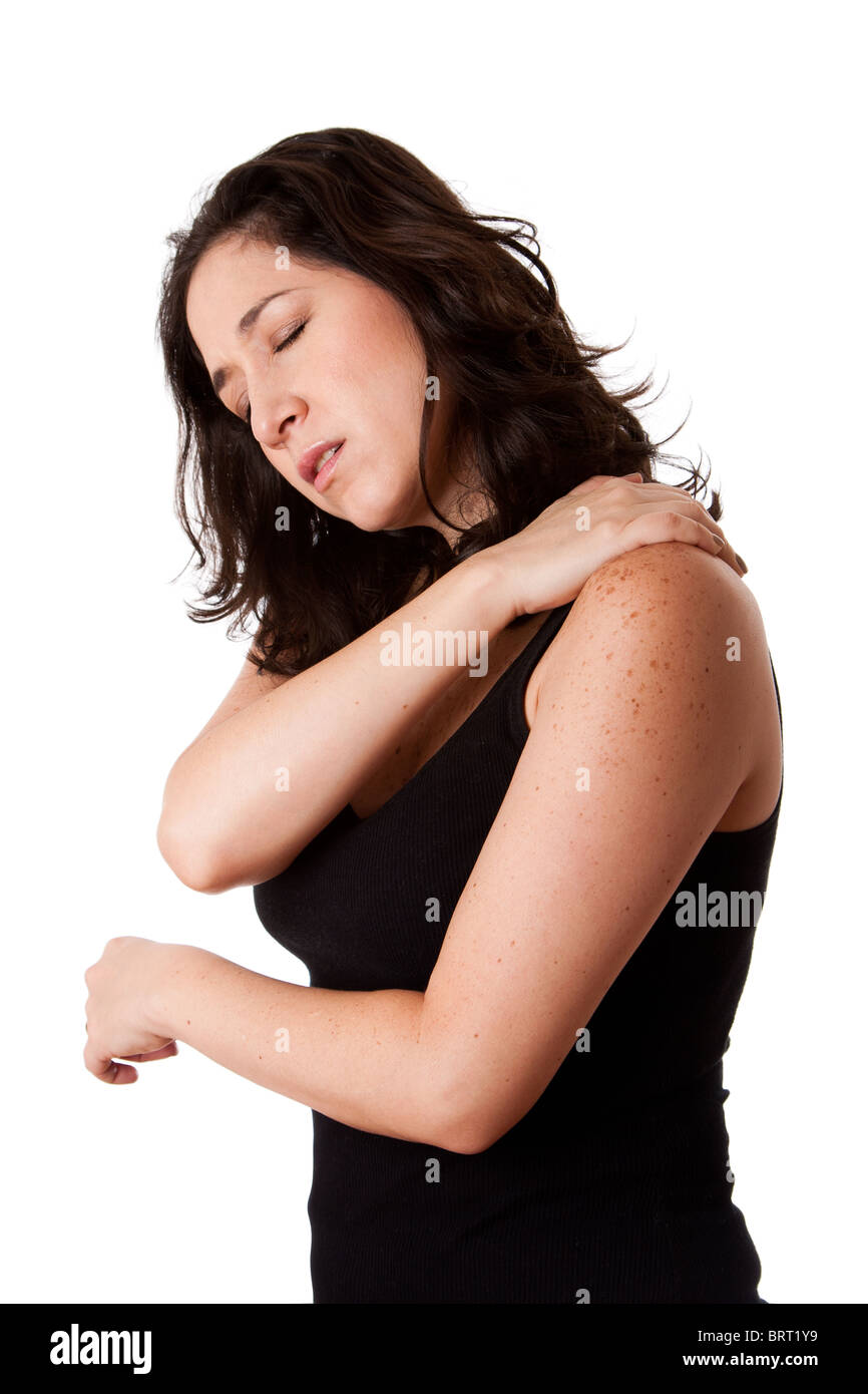 Beautiful woman holding her shoulder with neck pain and ache due to stress,wearing a sporty black tank top, isolated. Stock Photo