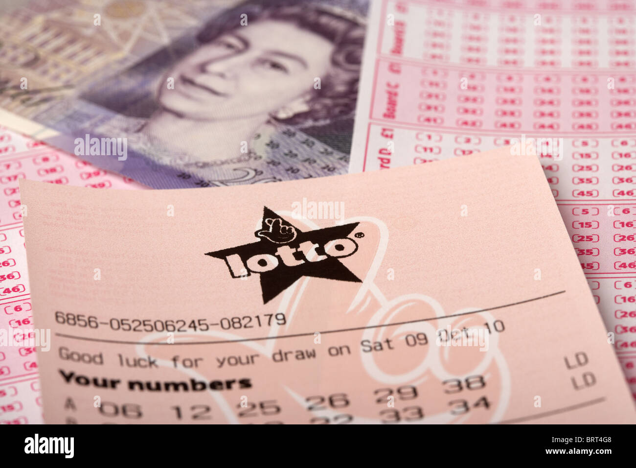 uk british national lottery lotto ticket with picks and twenty pound note Stock Photo