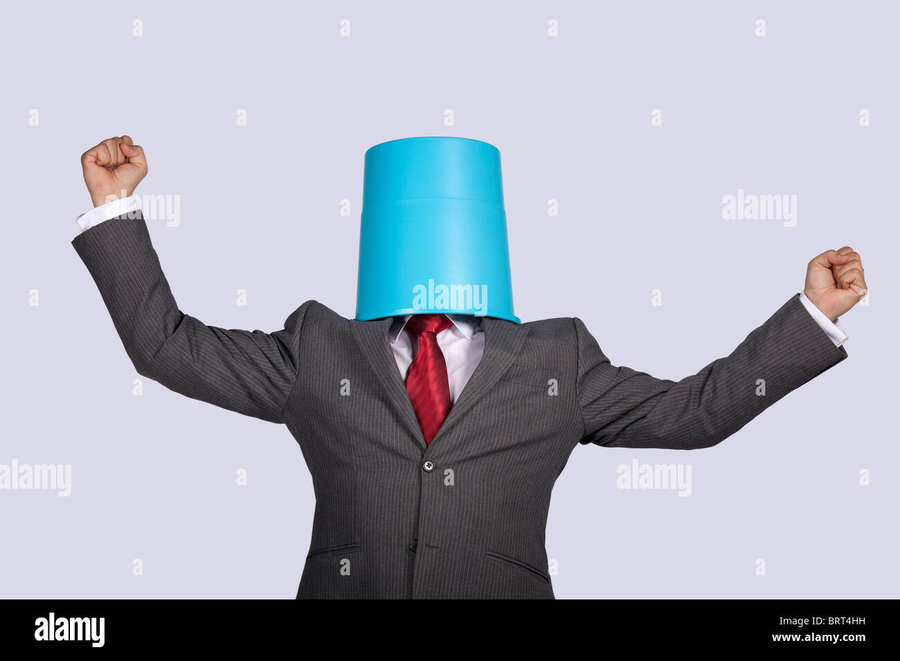 successful businessman with a bucket on his head Stock Photo