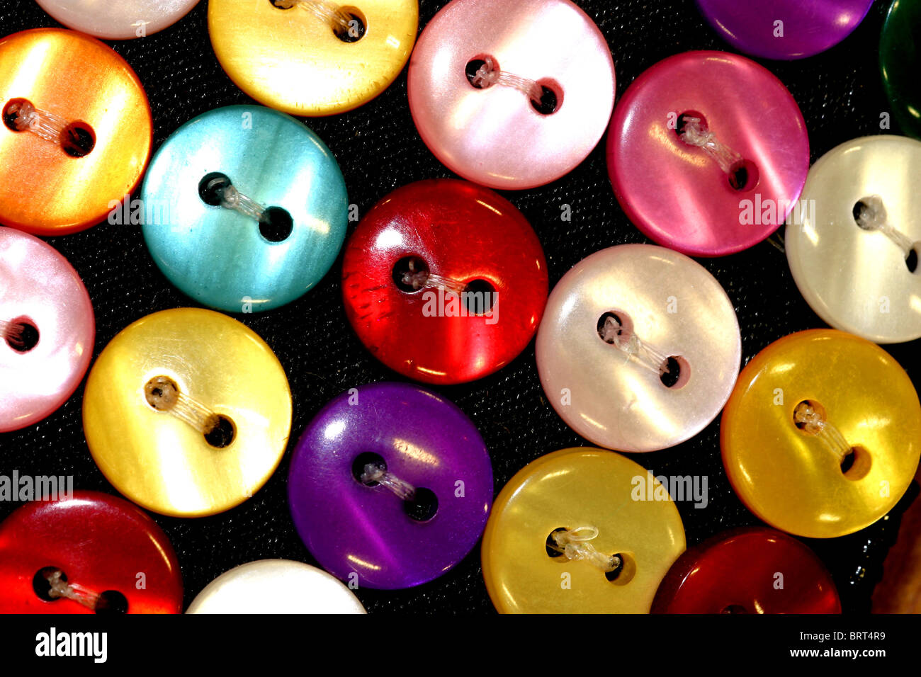 Colourful buttons sewn on cloth Stock Photo Alamy