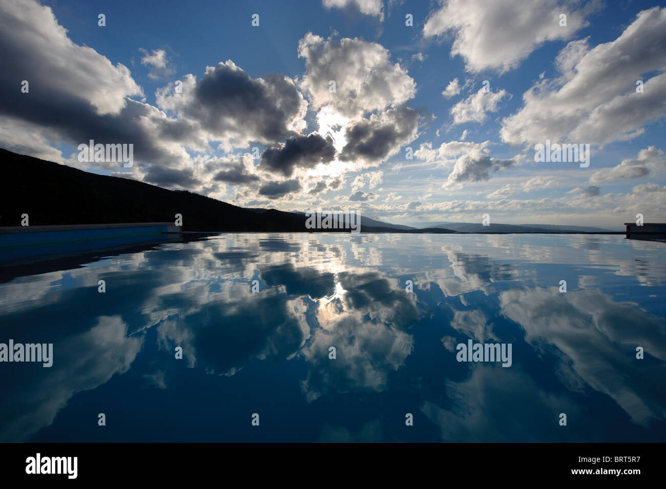 Cloudy sky reflected in the water of a outdoor swimming pool Stock ...