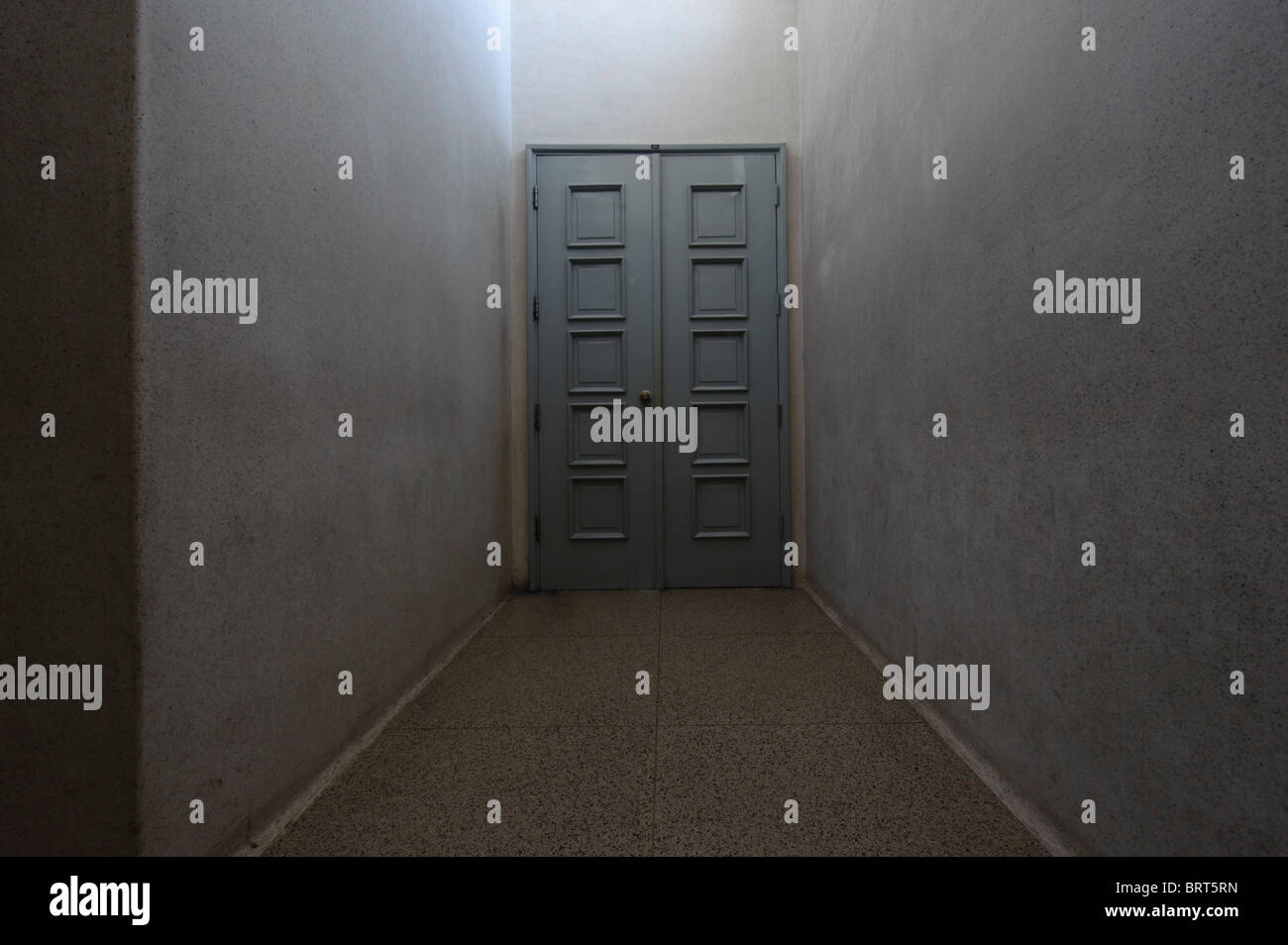 Closed door at the end of a dark corridor Stock Photo Alamy