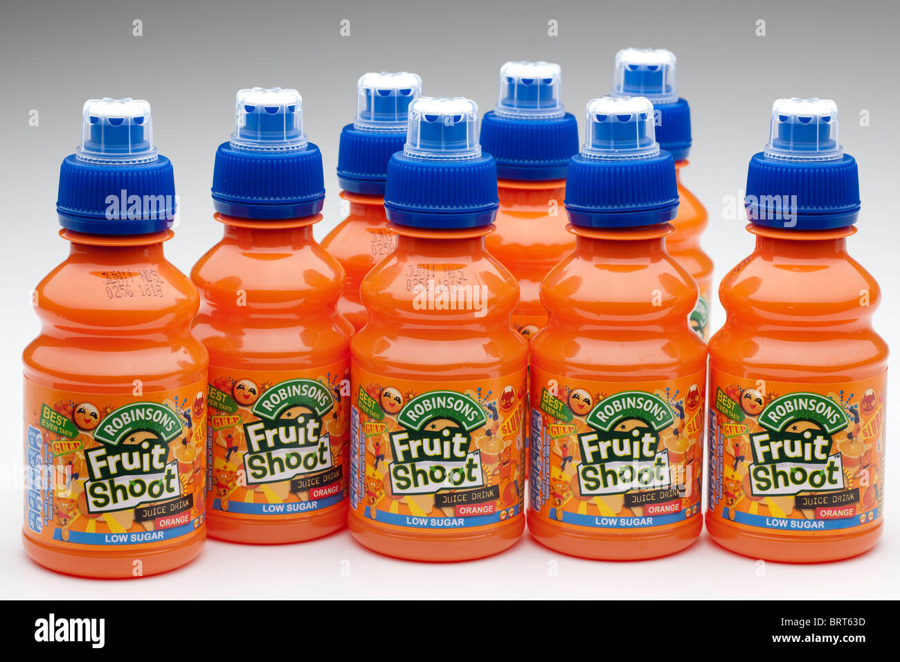 Eight plastic bottles of Robinsons Fruit Shoot orange juice drink made from concentrate Stock Photo