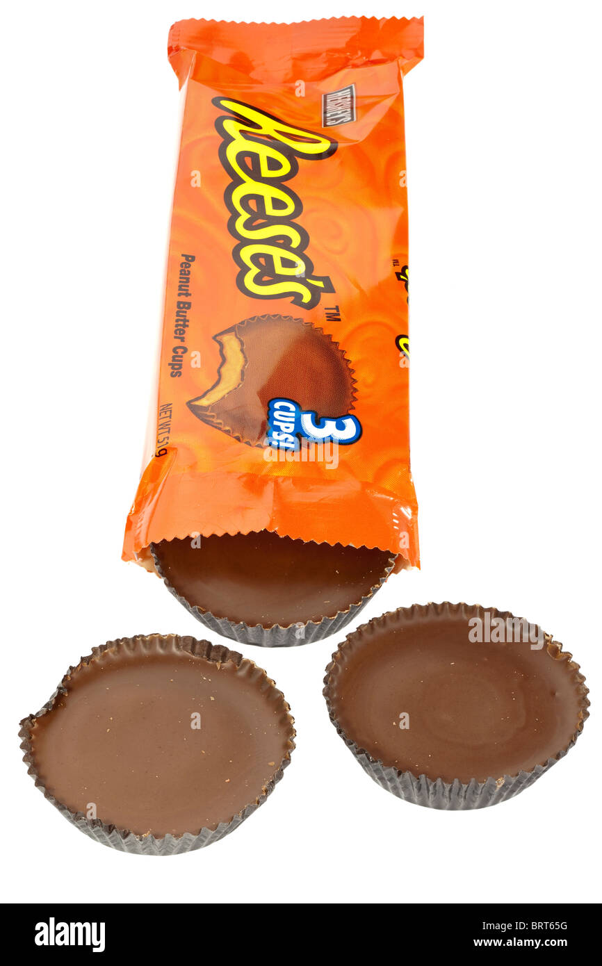 Orange packet of Hersheys Reeses chocolate covered peanut butter cups opened spilling onto a white surface Stock Photo
