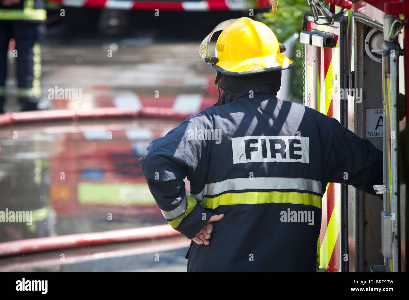 Firefighter brigade at work. Shallow depth of field. Stock Photo
