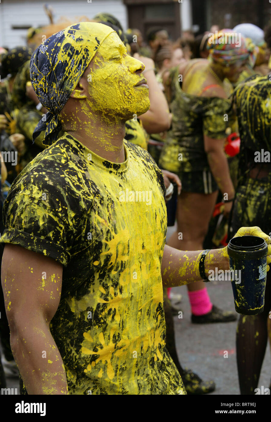 Nottinghill Carnival 2010. Reveler Covered in Yellow Paint. Stock Photo