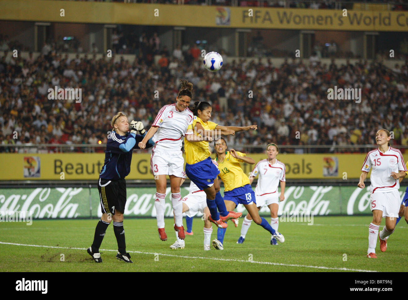 Katrine Pedersen of Denmark (3) and Cristiane of Brazil (r) fight for a header during a 2007 Women's World Cup match. Stock Photo