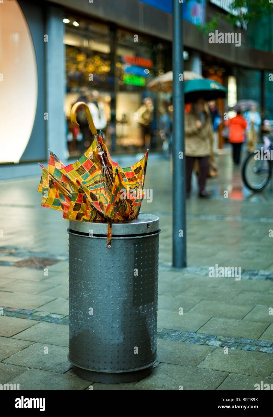 broken umbrella discarded on rainy street Stock Photo Alamy