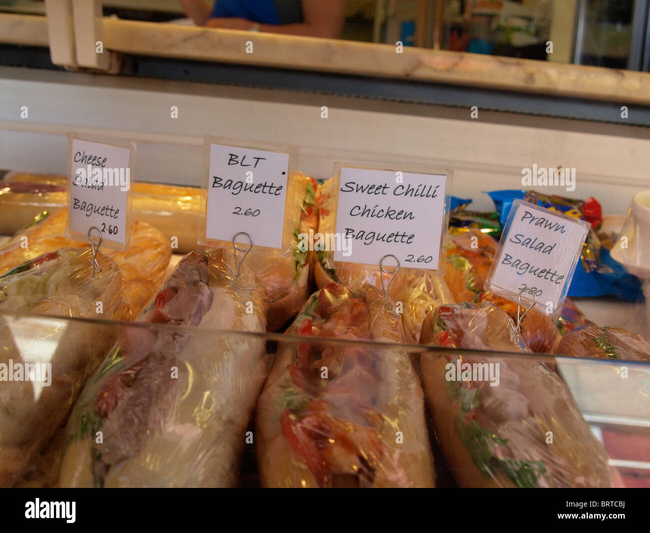 Baguettes for sale in bakery shop window, Newquay, Cornwall, UK Stock