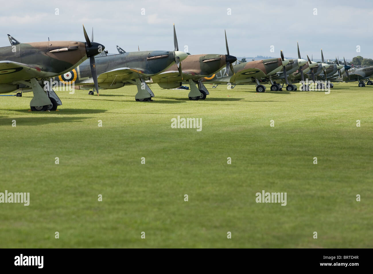 An impressive line up of 3 Hurricanes and 7 Spitfires on the grass in the sunshine Stock Photo