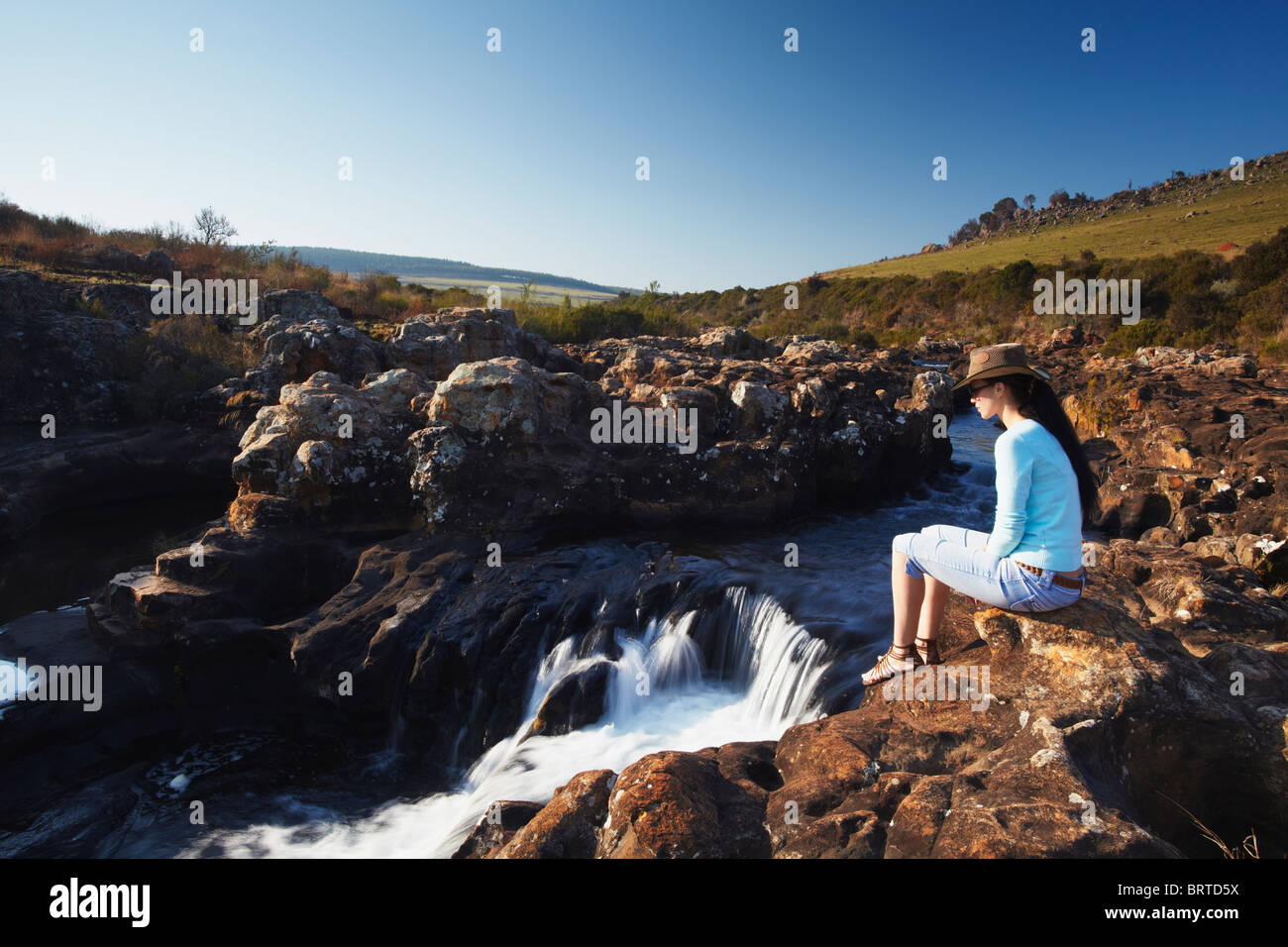 Woman at Lisbon Falls, Drakensberg Escarpment, Mpumalanga, South Africa (MR) Stock Photo