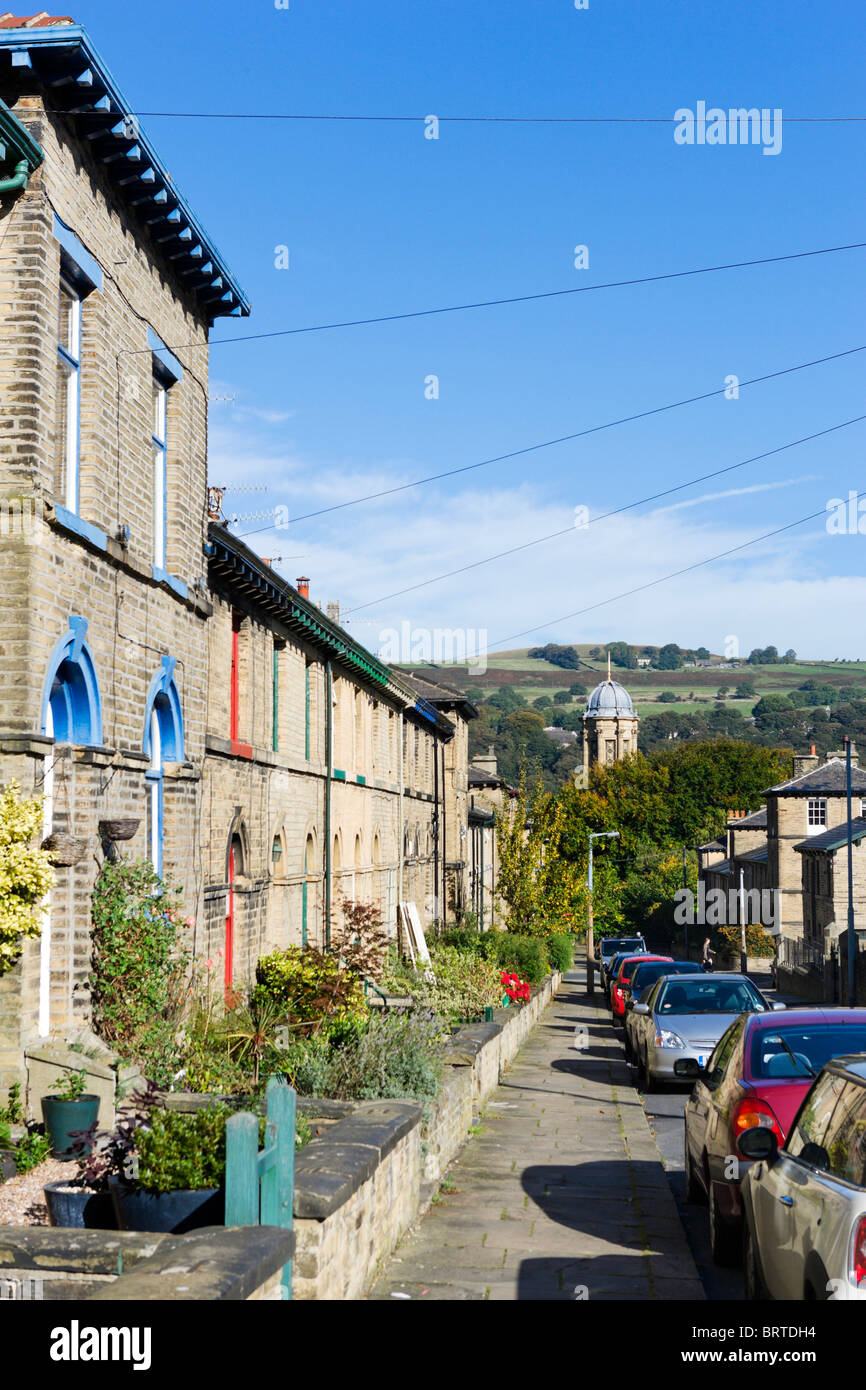 Terraced houses with the dome of the United Reformed Church behind, Saltaire, Bradford, West Yorkshire, England, UK Stock Photo