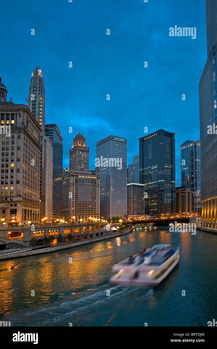 Chicago Skyline And Skyscrapers At Night With River Tour Boat On