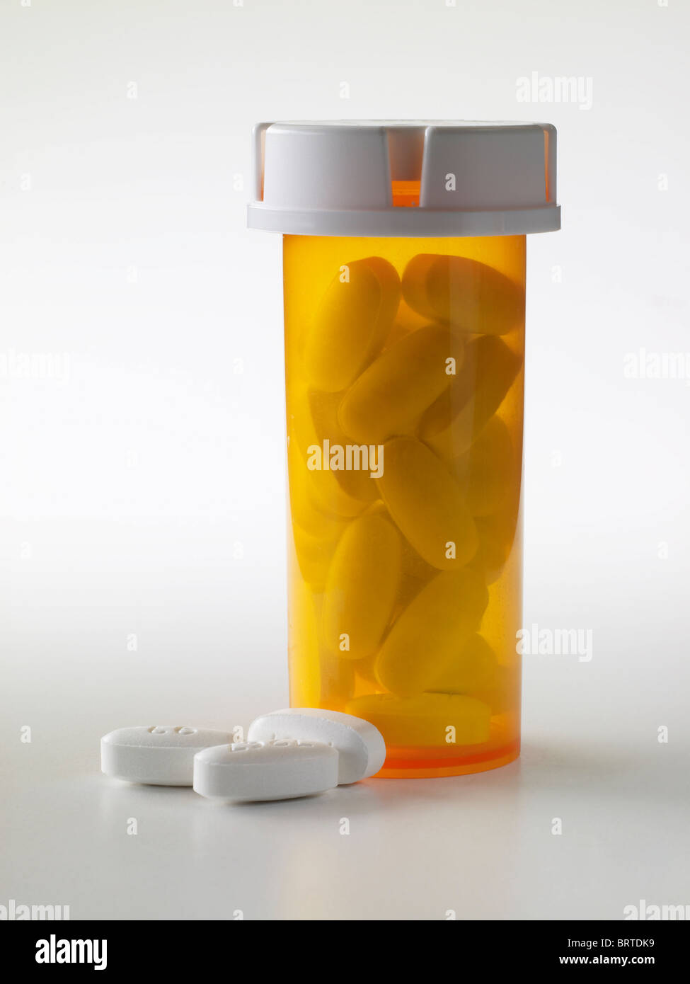 White Pills Spilling Out Of Prescription Drug Medicine Bottle, USA Stock Photo