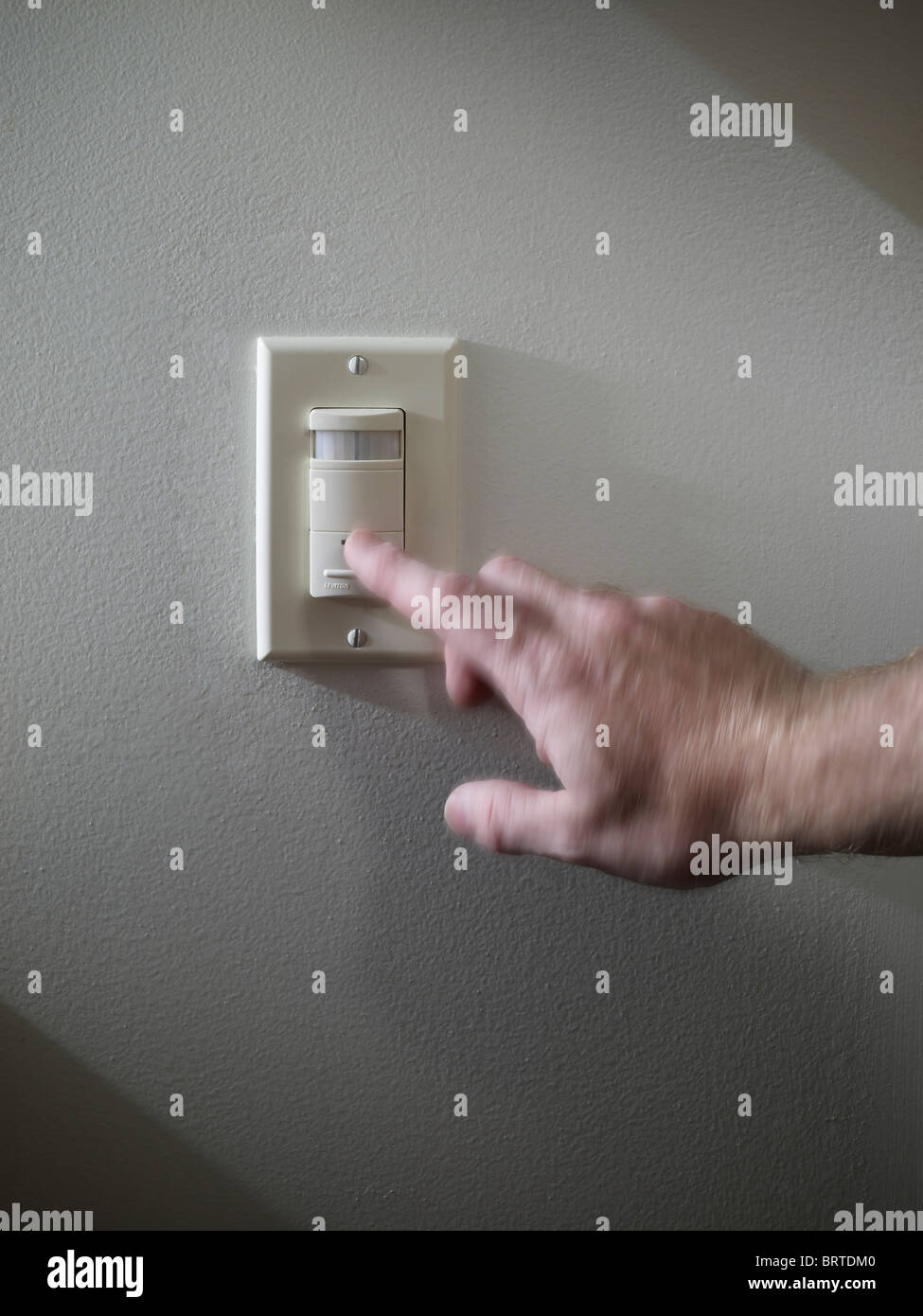 Turning Off Energy Conserving Light Switch, USA Stock Photo