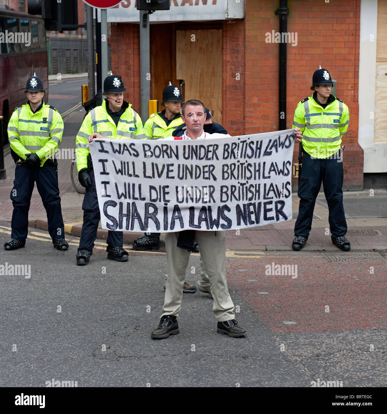 A protestor holds a written banner as The English Defence League demonstrate in Leicester. 9th October 2010. Stock Photo