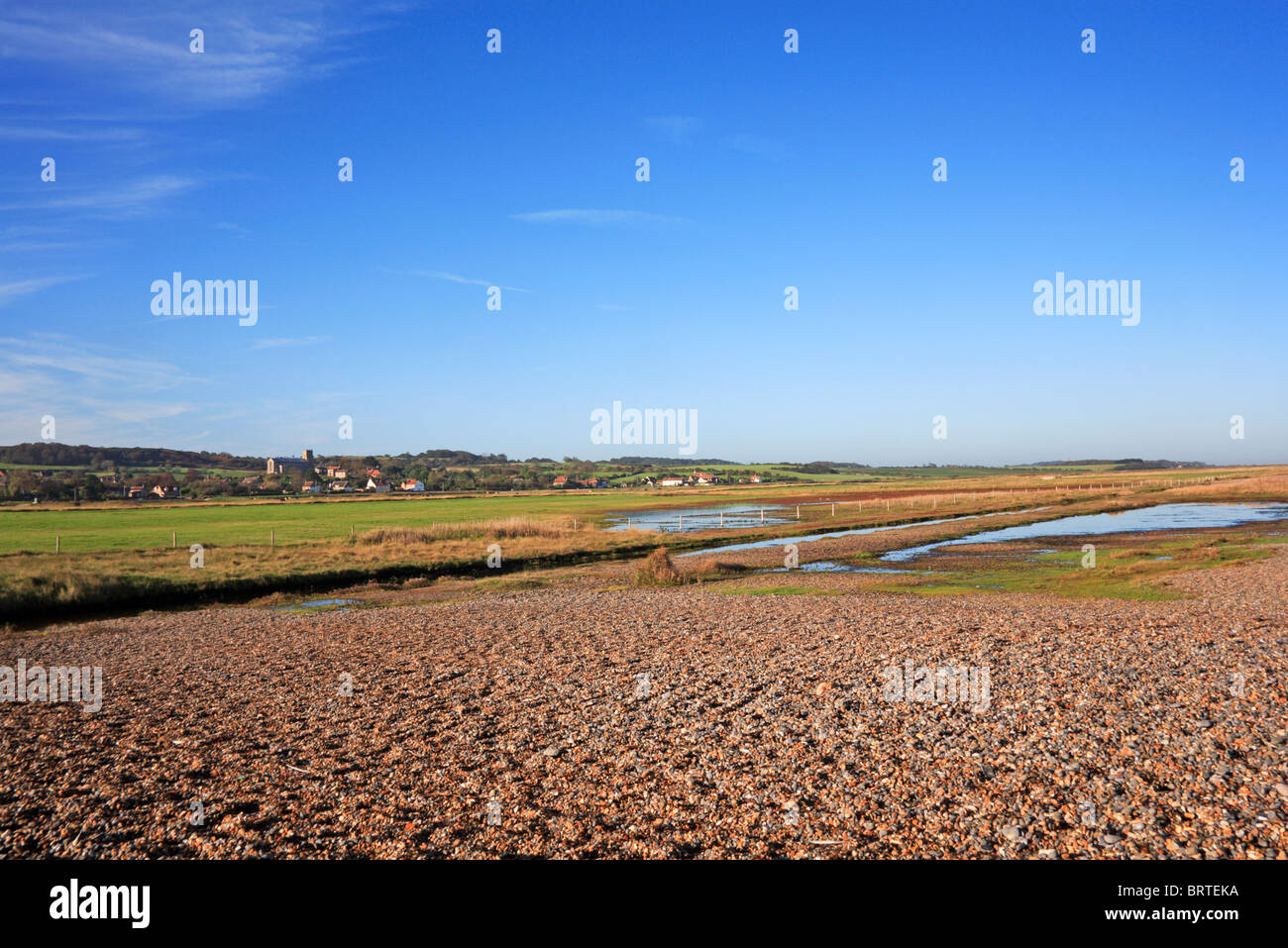 A view of Salthouse Marshes with the village of Salthouse, Norfolk, England, United Kingdom, in the background. Stock Photo