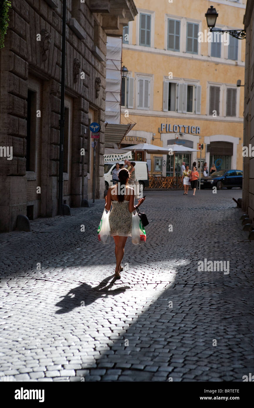 girl walking walk street shopping bags Rome Italy young woman discount buying market scene tourist touristic tourism travel dest Stock Photo