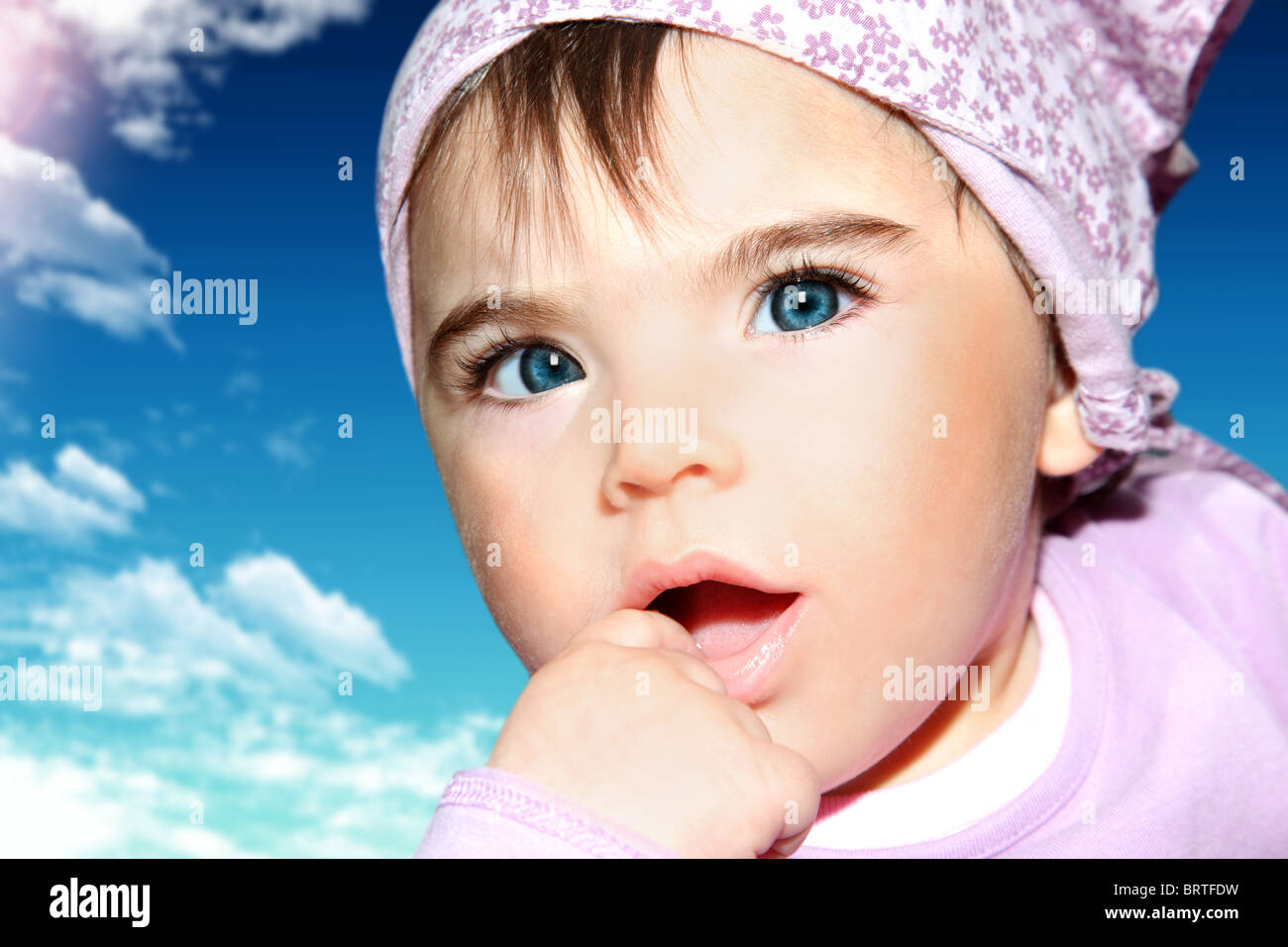 Little girl closeup portrait over blue sky Stock Photo - Alamy