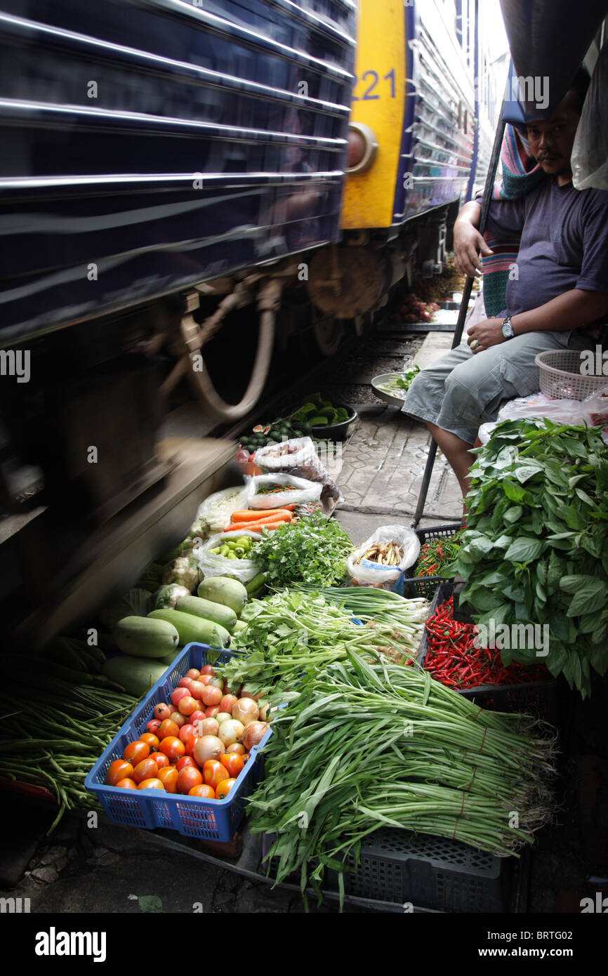 A food market on the rail tracks , Maeklong railway market , Thailand