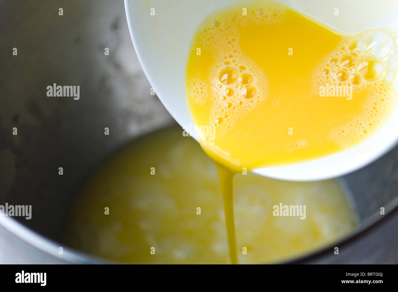 Adding egg to dough Stock Photo Alamy