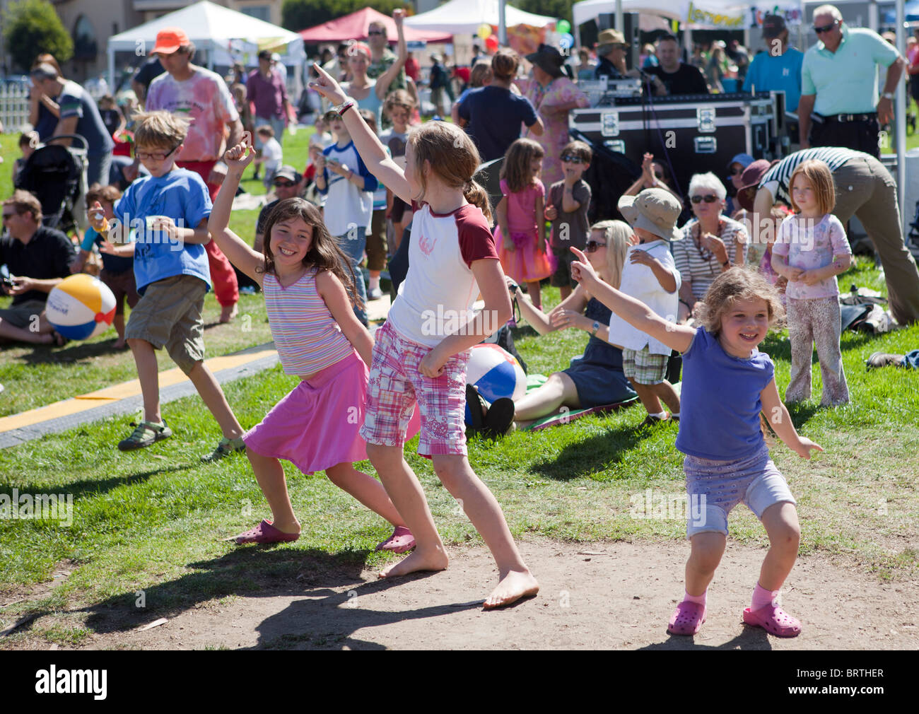 Children dance at an outdoor music festival Stock Photo