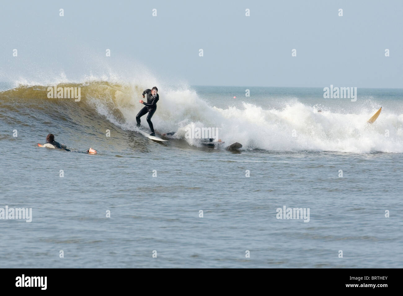 Surfers avoiding a collision in a wipeout in the 'Trap' in Aberystwyth Stock Photo