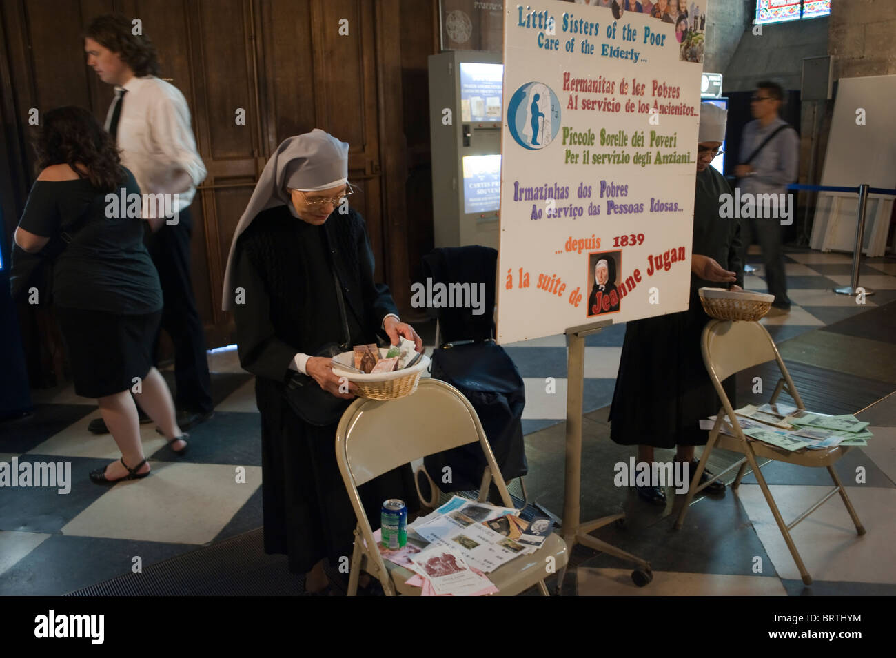 Paris, France - Catholic Nun Collecting Contributions, Money from Public, inside Notre Dame Cathedral, different cultures religion, French Catholic Church, european religious practice Stock Photo