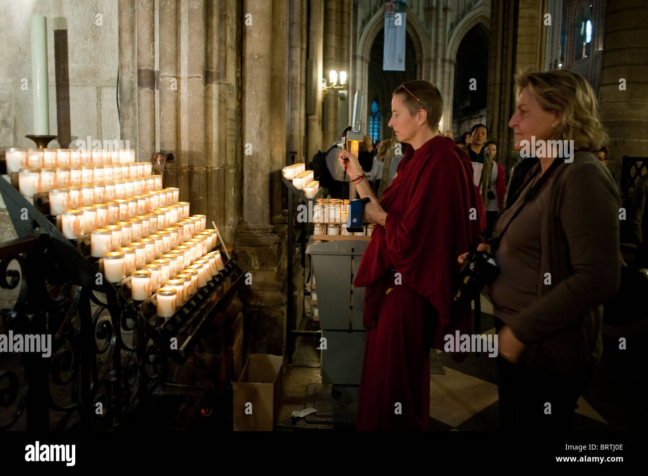 Paris, France Female Buddhist Monk Lighting Candles in French