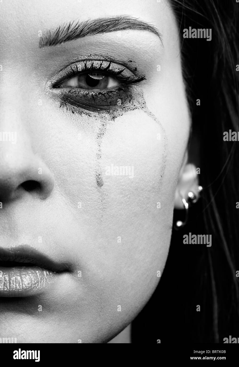 close-up portrait of beautiful crying girl with smeared mascara Stock Photo