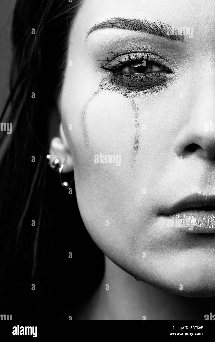 close-up portrait of beautiful crying girl with smeared mascara Stock Photo