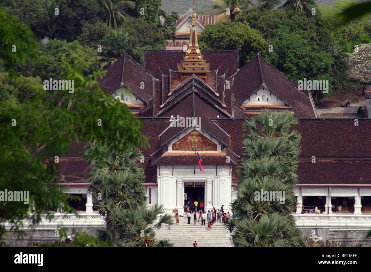 The Royal Palace Museum is seen from above being visited by tourists in Luang Prabang, Laos. Stock Photo