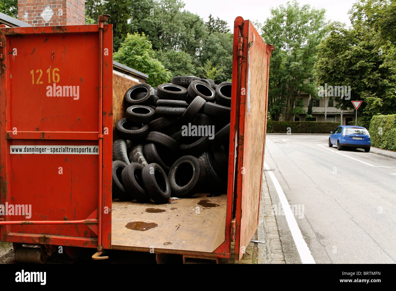 Old Rubber Car and Truck Tyers in Container Stock Photo