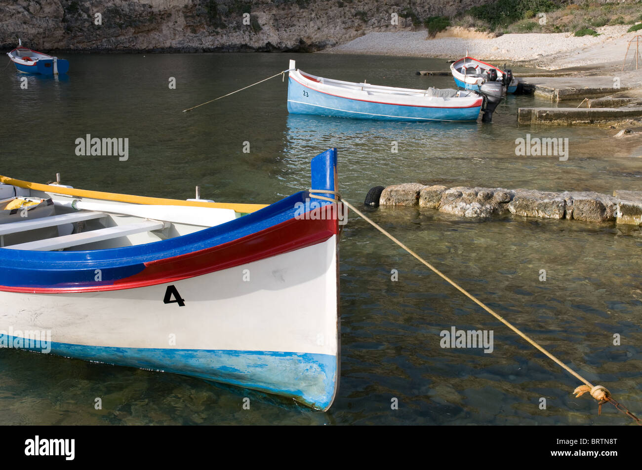 Maltese fishing boats in the inland sea at Dwerjra Gozo used for trips through the caves Stock Photo