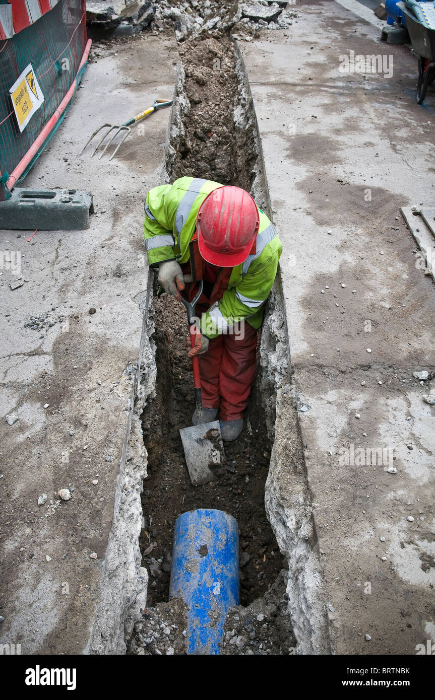Water engineer refurbishing water pipes in the City of London, UK Stock