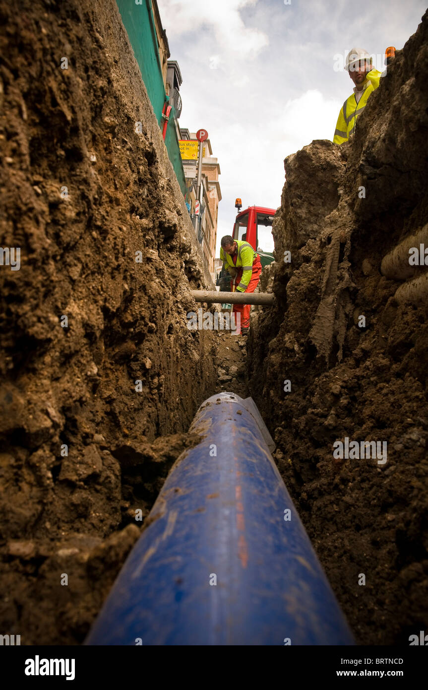 Water engineers refurbishing water pipes in the City of London, UK