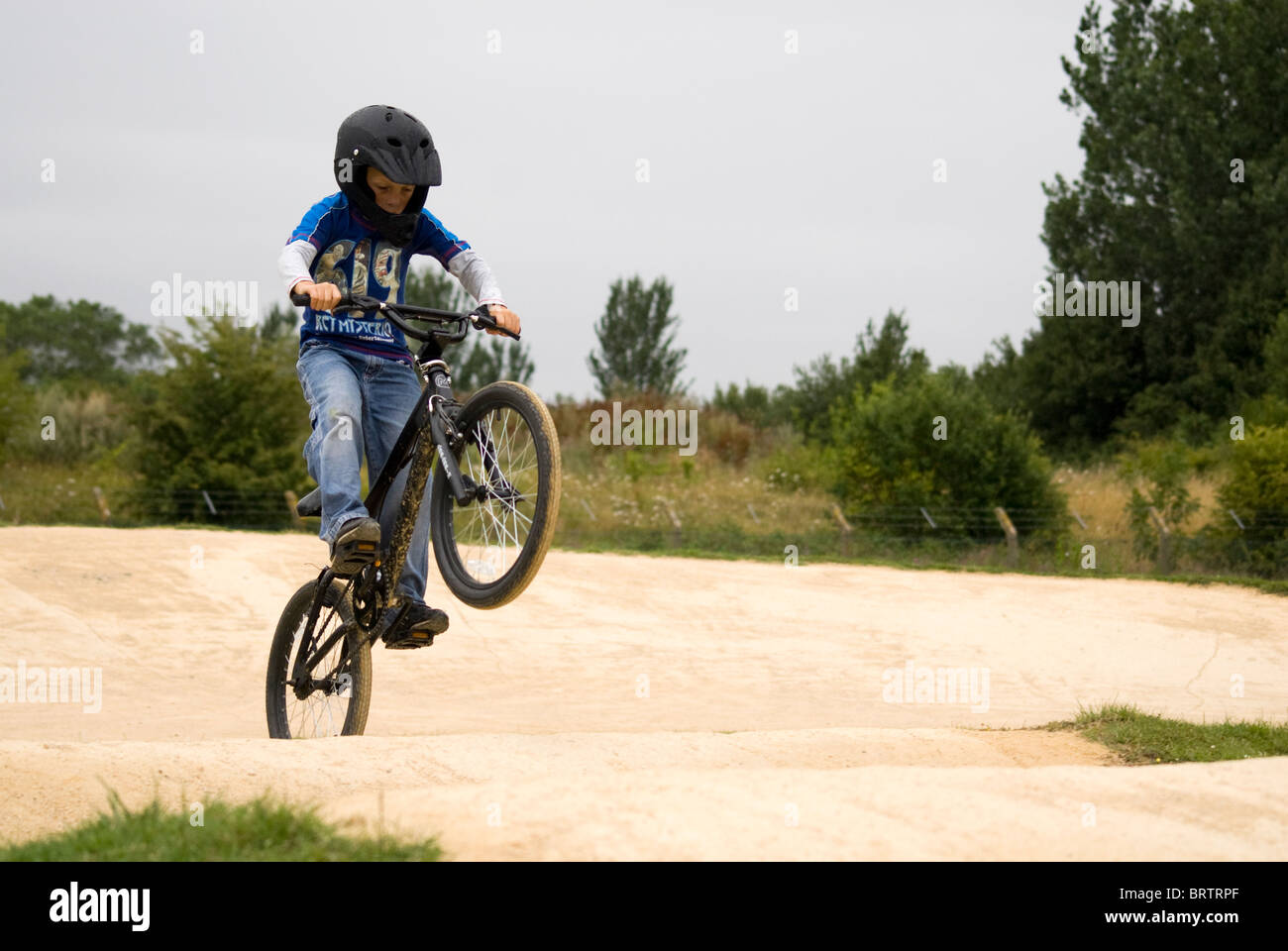 Child riding a BMX on a track Stock Photo Alamy