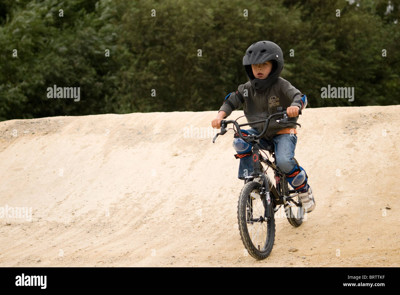 Child riding a BMX on a track Stock Photo Alamy