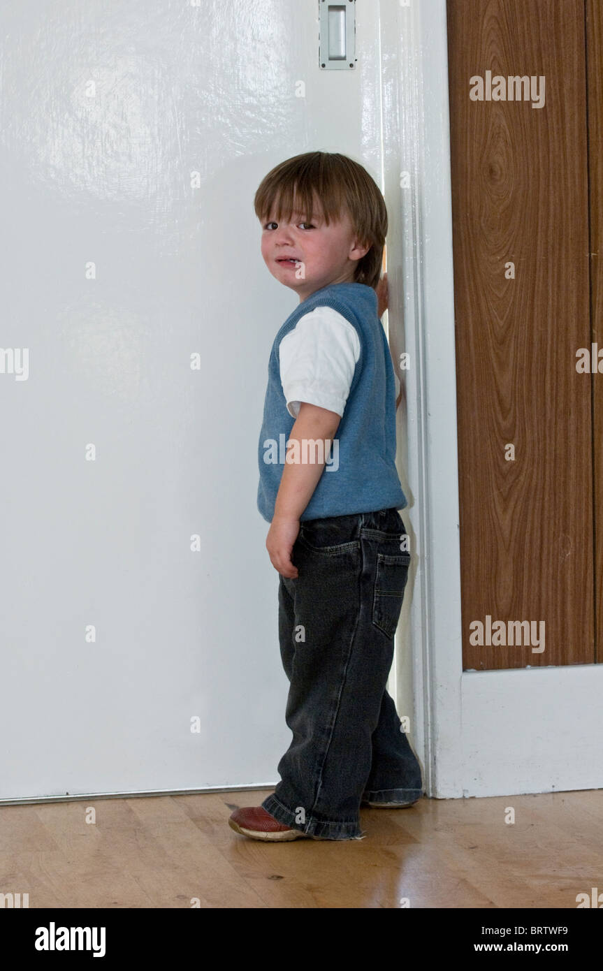 young child with his fingers trapped in a door Stock Photo
