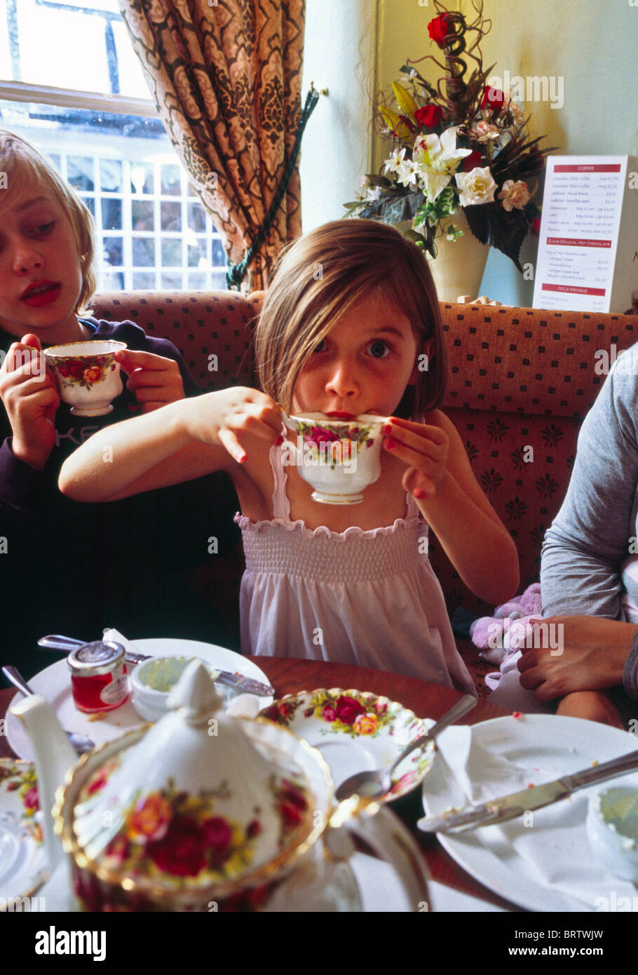 little girl drinking tea from a china cup Stock Photo Alamy