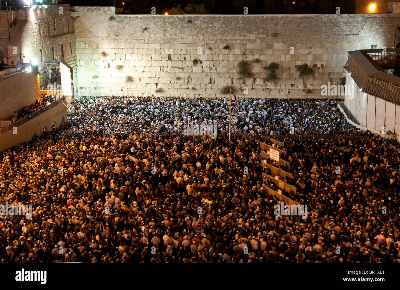 crowd of people praying at the western wall at night. Jeruslem. Israel Stock Photo